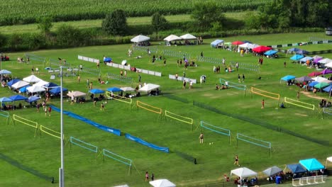 Zoomed-aerial-view-of-people-playing-grass-volleyball-at-tournament