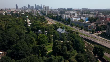 Aerial-View-of-Catholic-Church-and-Orthodox-Cemetery-and-Church-in-Wola-District-of-Warsaw,-Poland,-Drone-Shot