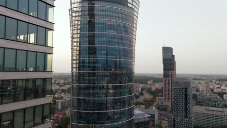 Aerial-View-of-Warsaw-Spire,-Modern-Skyscraper-and-Office-Building-in-Financial-District,-Revealing-Drone-Shot