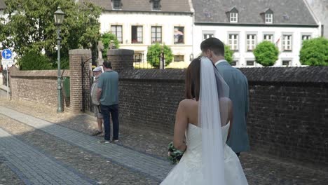 Wedding-couple-walking-down-the-small-streets-of-Thorn,-The-Netherlands