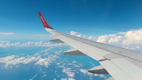 Shot-of-wing-of-an-airplane-flying-through-white-clouds-on-a-cloudy-day-in-Mexico-city,-Mexico