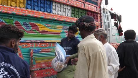 Flood-Relief-Package-Sacks-Lowered-From-Truck-In-Balochistan