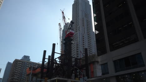 Wide-tilt-down-from-construction-crane-to-street-level-at-Bloor-and-Yonge