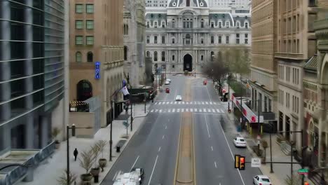 Aerial-view-over-a-quiet-street-towards-the-Philadelphia-City-Hall---tilt,-drone-shot