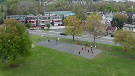 African-American-youth-boys-play-basketball-at-community-park-in-urban-city-setting-in-USA