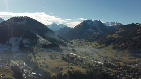 Stunning-Aerial-of-beautiful-valley-surrounded-by-Swiss-mountains