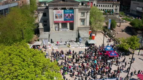Aerial-view-of-anti-vax-protestors-unfurling-a-slogan-banner-to-the-crowd