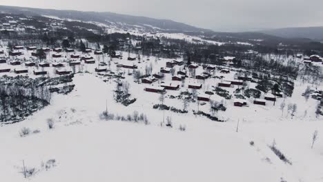 Panoramic-orbiting-aerial-over-rural-area-in-snowy-winter-landscape