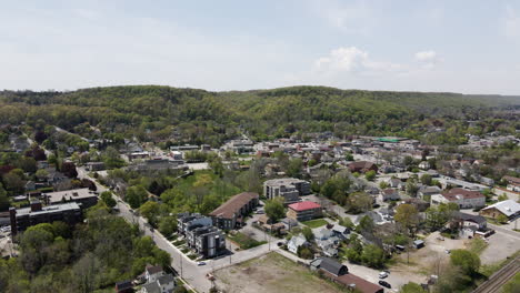 Aerial-flyover-Small-village-named-Grimsby-surrounded-by-greened-hills-and-trees-in-Canada