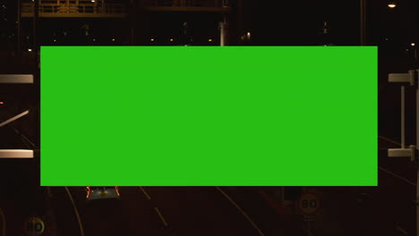 Night-city-street-billboard-stand-with-green-screen