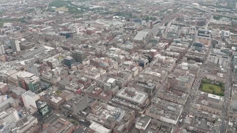 Dolly-forward-pan-down-drone-shot-of-Central-Glasgow-merchant-city-grid-streets
