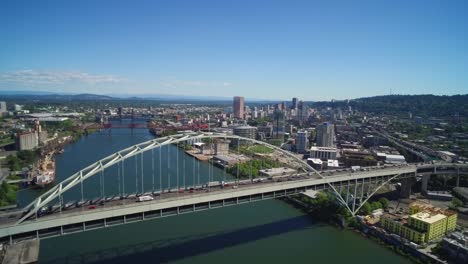 Aerial-showcasing-Portland-Oregon's-record-breaking-Fremont-Bridge-with-a-view-of-the-city-skyline