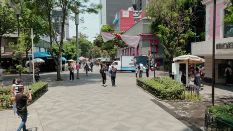 Aerial-dolly-in-establishing-shot-of-people-at-public-square-at-la-condesa