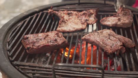 A-person-preparing-food,-a-delicious-meat-roasted-on-charcoal-on-a-spit