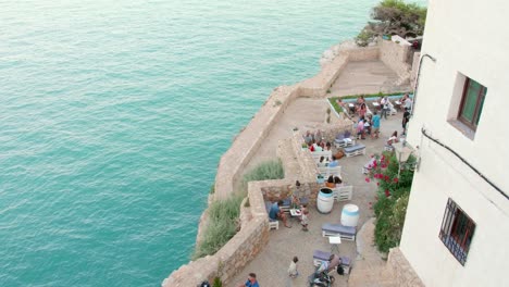 People-Gathered-At-The-Bar-Of-The-Peniscola-Fortress-During-Summer-In-Peniscola,-Castellon-Province,-Spain