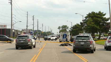 Motorcycle-accident-in-Toronto,-Canada---Police-and-EMS-vehicles-block-traffic-with-yellow-tape