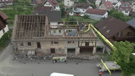 Workers-watch-the-demolished-building-from-crane