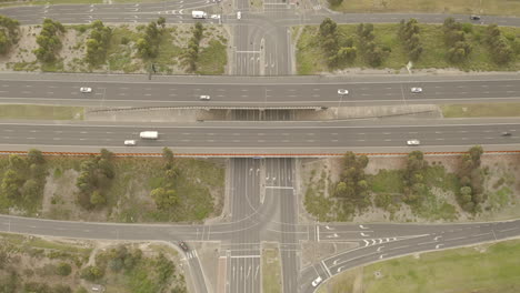 Static-aerial-perspective-of-major-highway-intersection-with-vehicles-traveling-in-all-directions