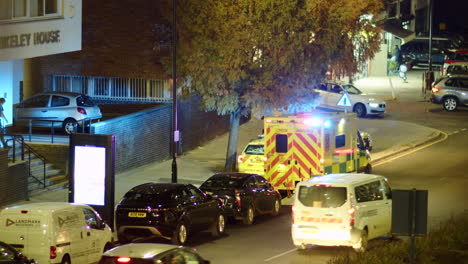A-paramedic-gets-into-an-ambulance-at-night-in-London,-England
