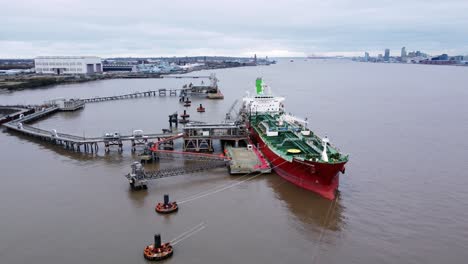 Silver-Rotterdam-chemical-oil-tanker-ship-loading-at-Tranmere-terminal-Liverpool-aerial-view-low-right-orbit-at-front