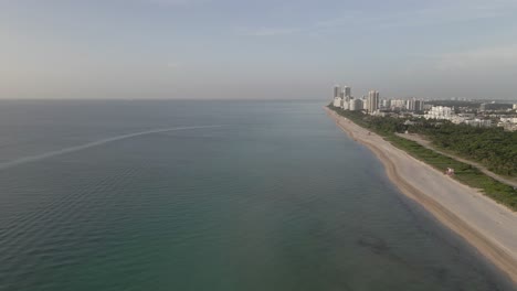 Aerial:-Sunrise-is-too-early-for-beach-goers-at-Surfside-beach,-Miami