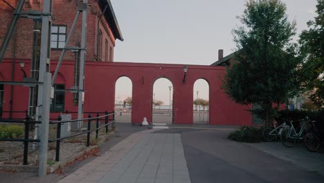 Going-Through-Ystad-Central-Station-Gateway-To-Harbour-With-Fire-Truck-Rescue,-Wide-Shot-Tracking-Forward