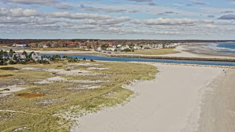 Wells-Maine-Aerial-v6-cinematic-drone-fly-around-beautiful-sandy-beach-and-rural-homes-along-the-river-estuary-and-sea-wall-leading-to-the-open-ocean-on-a-sunny-day---October-2020