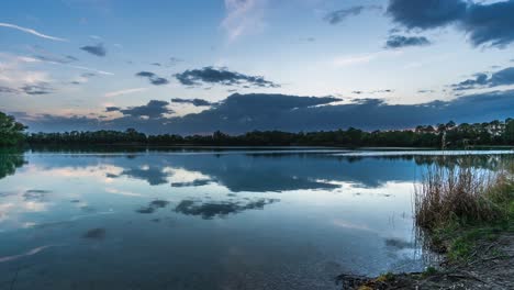 Lake-landscape-timelapse,-stunning-nature-background-with-clouds-reflecting-in-the-water-during-the-day