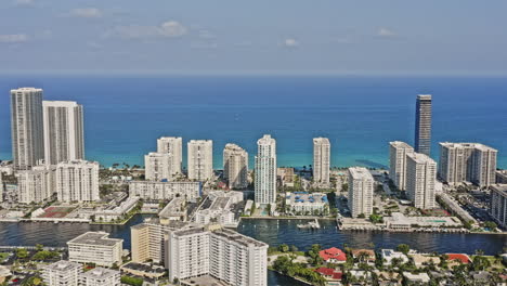 Hallandale-Beach-Florida-Aerial-v5-drone-hovering-around-the-golden-isles-capturing-the-expensive-modern-high-rise-buildings,-beachfront-residential-towers-and-resorts---March-2021