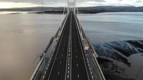 Zooming-out-drone-shot-of-the-Severn-Bridge-linking-England-with-Wales-near-to-Bristol,-UK