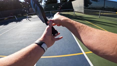 Pickleball-Player-Spinning-Paddle-Racquet-in-his-Hands---1st-Person-POV