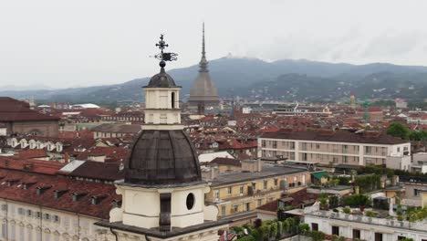 Church-tower-and-city-skyline-of-Turin,-aerial-drone-orbit-view