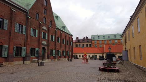 Timelapse-of-Kronhuset-red-brick-building-in-Vastra-Nordstaden,-Gothenburg,-Sweden