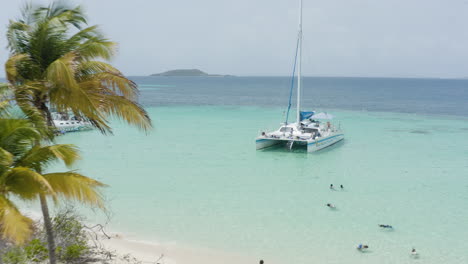 AERIAL---Catamaran-boat-on-clear-waters,-Cayo-Icacos,-Puerto-Rico,-forward