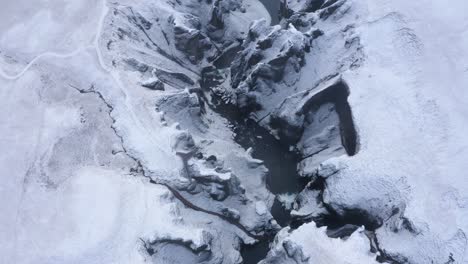 Fjaðrárgljúfur-Canyon-in-South-Iceland-during-Winter---aerial-top-down