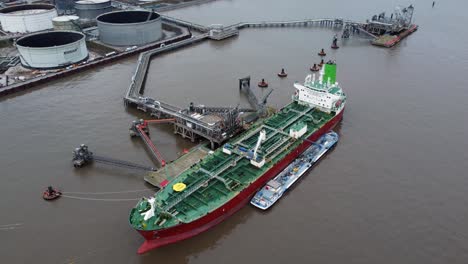 Silver-Rotterdam-oil-petrochemical-shipping-tanker-loading-at-Tranmere-terminal-Liverpool-aerial-view-pull-away-left-rotation