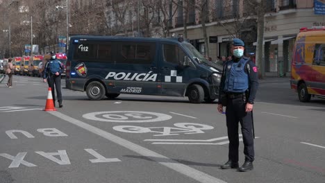 A-police-officer-stays-alert-during-police-and-medical-emergency-evacuation-exercise-drill-in-Madrid,-Spain