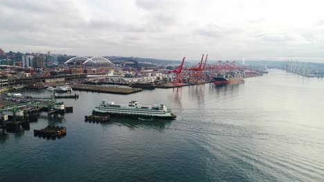 Aerial-shot-pulling-away-from-two-ferries-pulling-into-the-Seattle-harbor