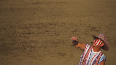 Rodeo-clown-throws-football-for-entertainment-at-Montana-rodeo-circuit