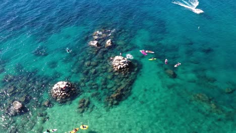 Aerial-View-Of-Kayaks-In-The-Blue-Sea---drone-shot