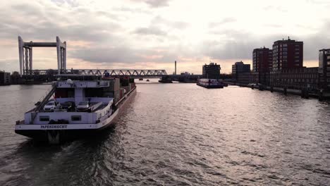 Aerial-View-From-Stern-Of-Salute-Cargo-Container-Ship-Approaching-Spoorbrug-Railway-Bridge-Along-Oude-Maas