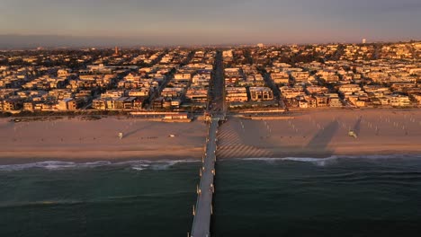 Manhattan-Beach-Pier-At-Sunset-In-Los-Angeles,-California---aerial-pullback