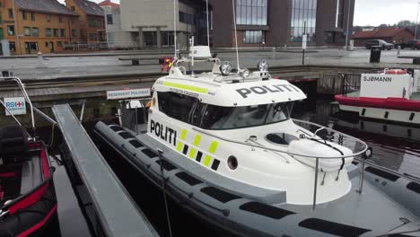 Stavanger-police-boat-closeup---Backward-moving-aerial-while-boat-is-moored-in-city-of-Stavanger-in-southern-Norway