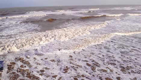 Aerial-Flying-Over-Rough-Sea-Waves-Along-Katwijk-aan-Zee-Beach-Coastline-In-South-Holland