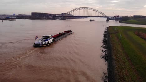 Aerial-Dolly-Back-Over-Stedo-Inland-Freighter-Heading-Towards-Alblasserdamsebrug-In-Ridderkerk