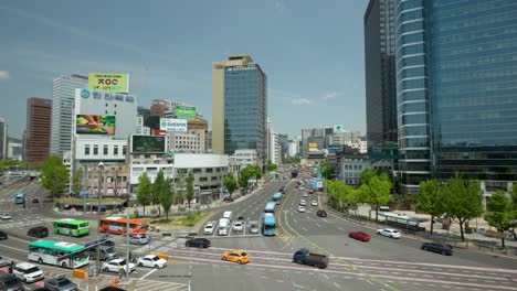 Cars-Traffic-on-Crossroads-near-Seoul-Station-with-Wise-Tower-and-Yonsei-Severance-building-on-background