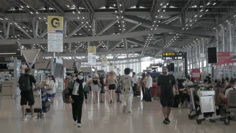 POV-Im-Abflugterminal-Des-Flughafens-Suvannabhumi-Mit-Vielen-Passagieren,-Die-Während-Der-Wiedereröffnung-Des-Landes-Spazieren-Gehen