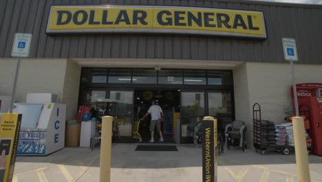 Customer-enters-dollar-general-super-wide-tilt-down-reveal