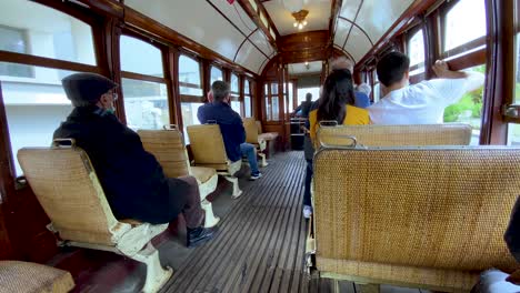 Passengers-Sitting-Inside-The-Tram-Traveling-Through-The-Porto-City-In-Portugal