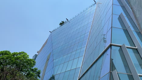 Tilt-Up-View-Outside-New-Torre-Manacar-Shopping-Centre-With-Sloped-Window-Pane-Facade-In-Mexico-City